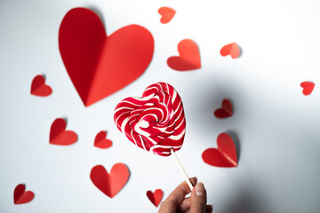 Valentine's Day background. red hearts and lollipop on white background. Valentines day concept. Flat lay, top view, copy space