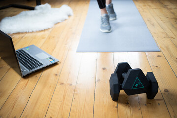 woman doing exercise at home focus on dumbells