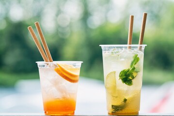 Cold ice beverage alcohol drink with fruits. Drikk with lemon and orange and ice.