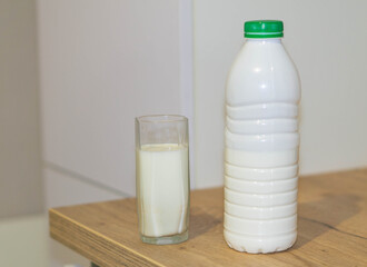 milk bottle and glass on wooden table