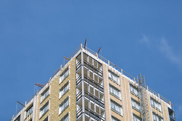 Fototapeta premium Big apartment buildings under construction. Building under construction against blue sky