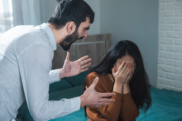 aggressive man beating woman
