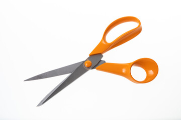 Used orange scissors on a white background 