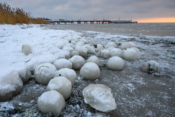 Natural ice balls on the beach in Jastarnia during winter. Hel Peninsula, Poland