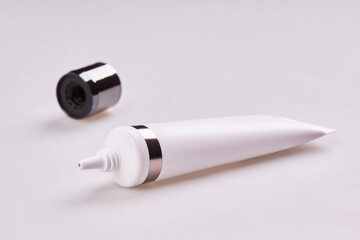 Blank tube of cream, concealer, toiletry. Face base tube with professional cosmetic products isolated on white background. Skincare and beauty concept. 