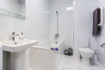 water tap sink with faucet in expensive bathroom. detail of a corner toilet with wall mount shower attachment