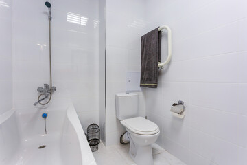 water tap sink with faucet in expensive bathroom. detail of a corner toilet with wall mount shower...