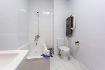 water tap sink with faucet in expensive bathroom. detail of a corner toilet with wall mount shower attachment