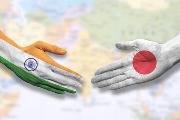 India and Japan - Flag handshake symbolizing partnership and cooperation