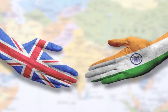 India and UK - Flag handshake symbolizing partnership and cooperation with the United Kingdom

