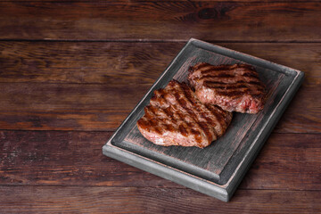 Fresh juicy delicious beef steak on a dark background