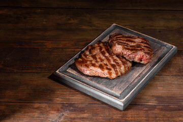 Fresh juicy delicious beef steak on a dark background