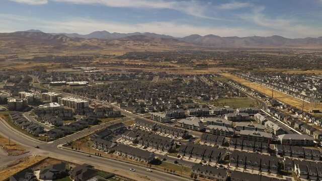 Aerial shot circling around suburban housing development with park