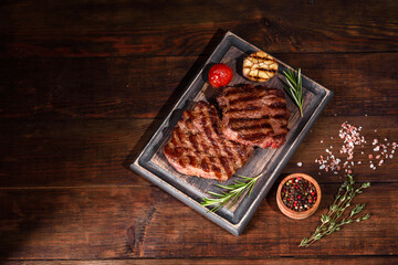 Fresh juicy delicious beef steak on a dark background