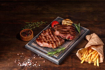 Fresh juicy delicious beef steak on a dark background