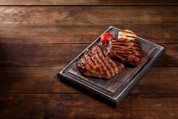 Fresh juicy delicious beef steak on a dark background