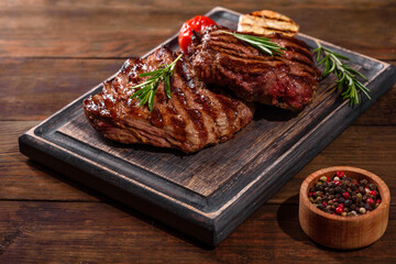 Fresh juicy delicious beef steak on a dark background