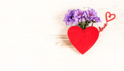 Plakat Red heart with a bouquet of flowers on an isolated background. Top view of holiday card