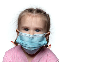 Cute little girl with pigtails and in the mask looks at the camera
