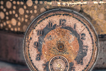 Vintage grunge background of an old clock. Abstract texture covered with dust, dirt, scratches. Macro photography in light tinted