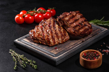 Fresh juicy delicious beef steak on a dark background