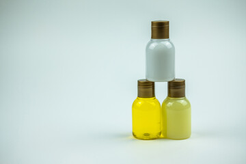 Obraz na płótnie Canvas A beautiful photo of a three bottles of shampoo making a pyramide