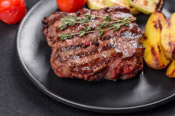 Fresh juicy delicious beef steak on a dark background