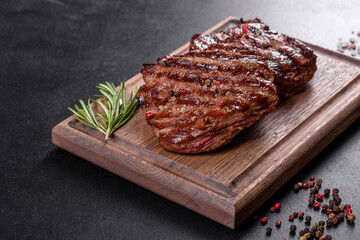 Fresh juicy delicious beef steak on a dark background