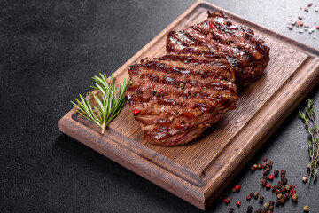 Fresh juicy delicious beef steak on a dark background