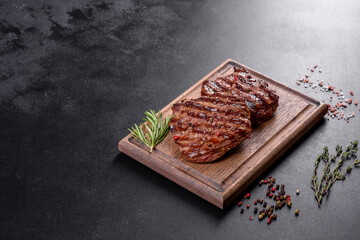 Fresh juicy delicious beef steak on a dark background