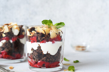 Dessert black forest in a glass on a light concrete background. Traditional German dessert. Black Forest cake.