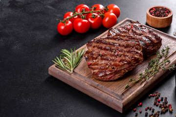 Fresh juicy delicious beef steak on a dark background