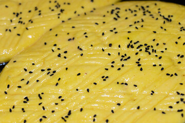 Homemade dough turkish pide bread with black cumin seeds ready to bake. Bakery background