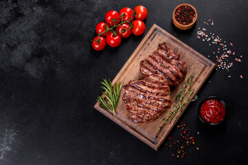 Fresh juicy delicious beef steak on a dark background