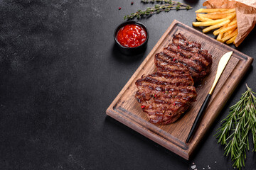 Fresh juicy delicious beef steak on a dark background