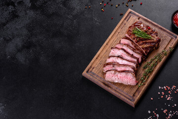 Fresh juicy delicious beef steak on a dark background
