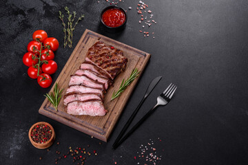 Fresh juicy delicious beef steak on a dark background