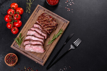 Fresh juicy delicious beef steak on a dark background
