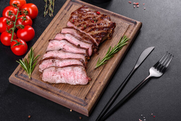 Fresh juicy delicious beef steak on a dark background