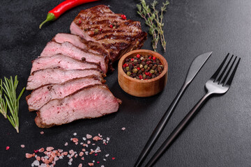 Fresh juicy delicious beef steak on a dark background