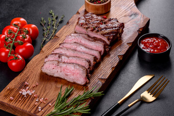 Fresh juicy delicious beef steak on a dark background