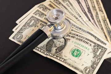 stethoscope and dollar bank notes