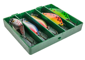 A close up of a plastic box of metal fishing lures used for bass and pike fishing isolated on a...