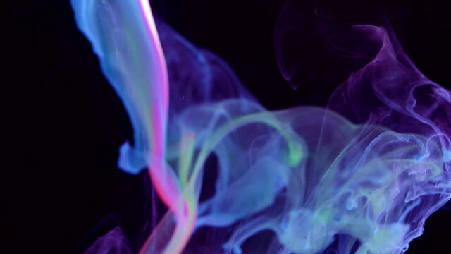 Acrylic colors in water. Ink blot. Abstract black background.