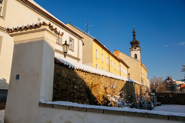 Fototapeta na wymiar Gothic Fortress walls in winter day, tower of church of Nativity of the Blessed Virgin Mary, Medieval fortifications, architectural monument, Pisek, Southern Bohemia, Czech Republic
