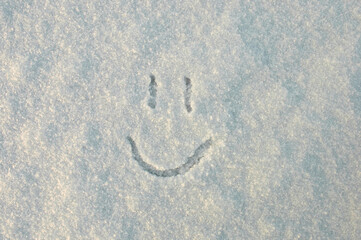a smile. in the photo a smile painted on white snow in winter