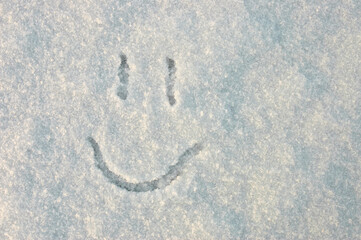a smile. in the photo a smile painted on white snow in winter