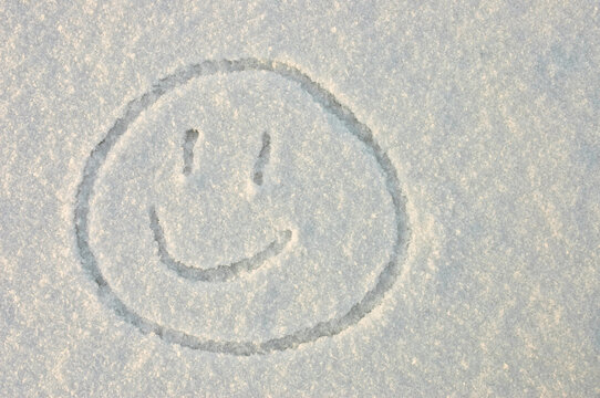 a smile. in the photo a smile painted on white snow in winter