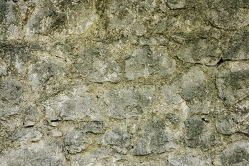 Natural old beige stone wall textured background. Close up. Copy space.