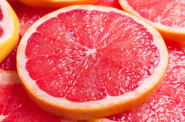 Red fresh juicy grapefruit slices. Close-up summer concept.